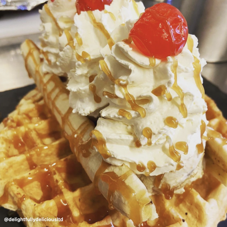 delightfully delicious waffles with caramel and whipped cream